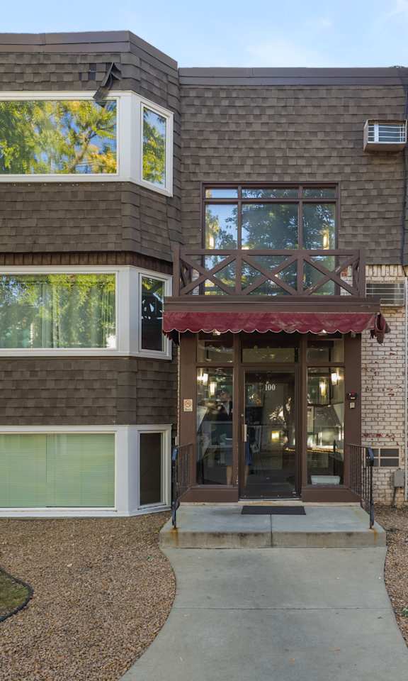 A modern house with a red awning at the entrance.