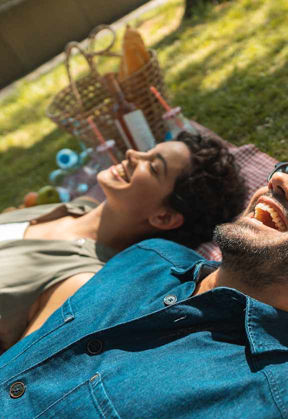 a man and a woman laying down on the grass
