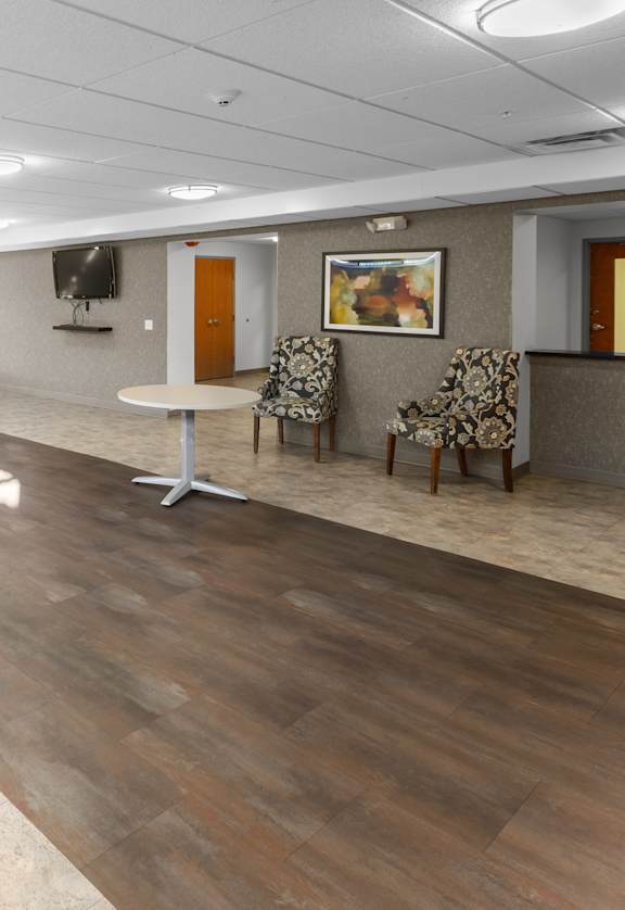 A conference room with a long table and chairs.
