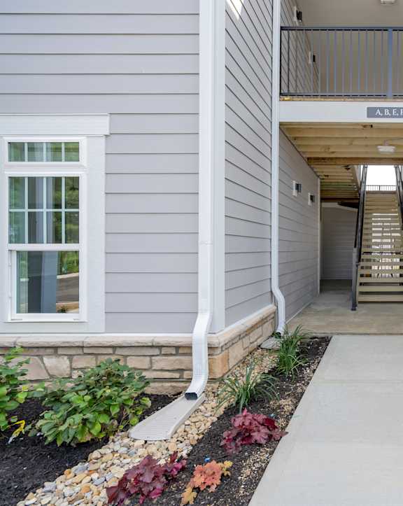 an outdoor kitchen with stainless steel appliances and bar stools