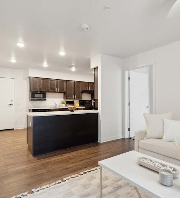a living room and kitchen with a couch and a table