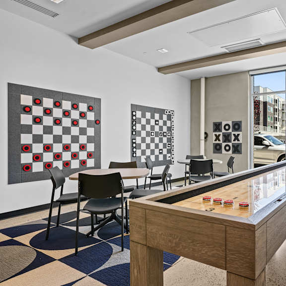 A room with a checkerboard patterned floor and a pool table.