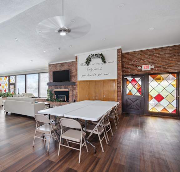 A room with a white ceiling and wooden floors has a banner that says "Only families.".
