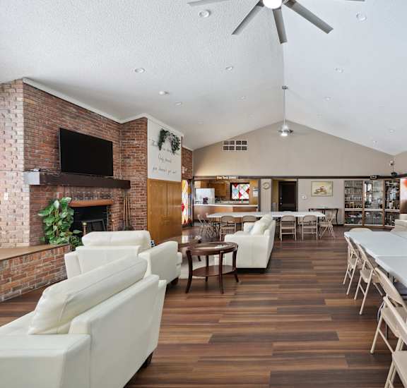 A room with a long table and chairs.