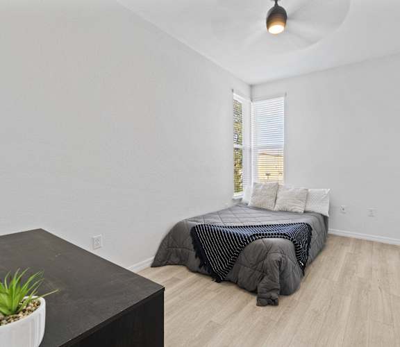 a bedroom with a bed and a large window