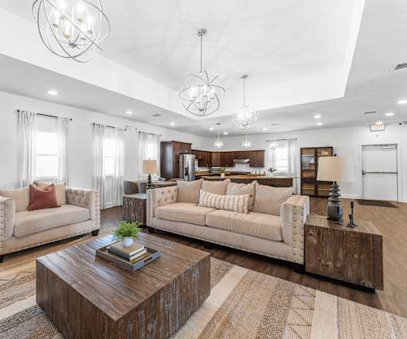 A modern living room with a wooden coffee table in the center.