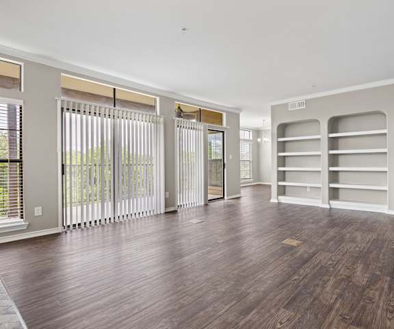 a living room with hardwood floors and white walls at Waters Edge Apartment Homes, Georgetown, TX, 78626
