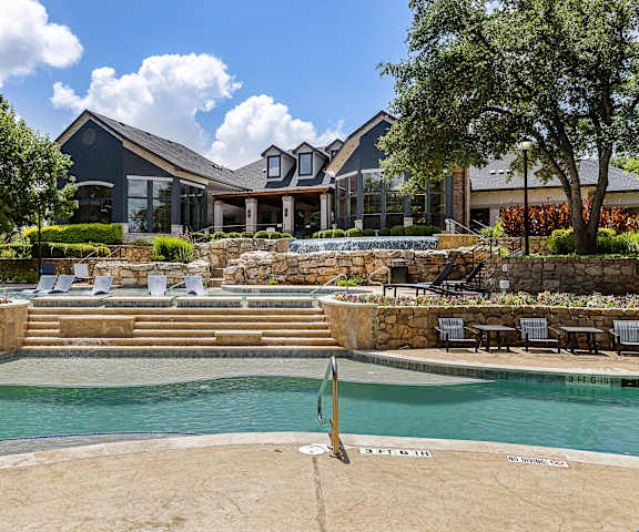 a swimming pool with a house in the background at The Vista on Brodie, Austin