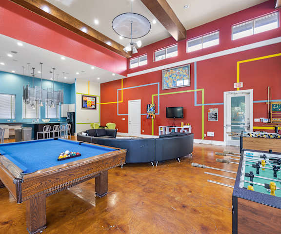 a recreation room with a pool table foosball table and a ping pong table at Artisan Apartments & Shops, Austin