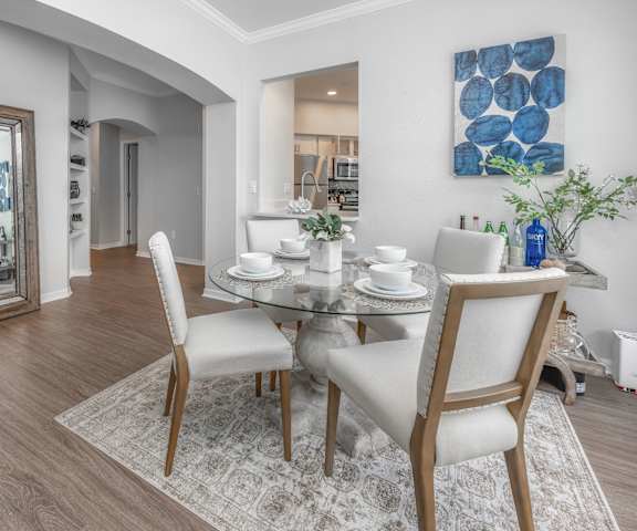 a dining room with a table and chairs and a mirror