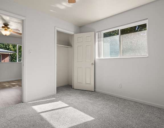 A room with a white door and a window with a white frame.
