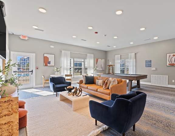 A spacious living room with a variety of furniture and decor.