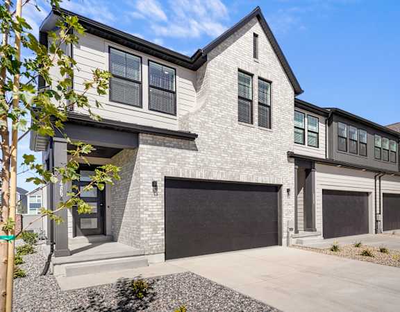 a new home with a garage door in front of it