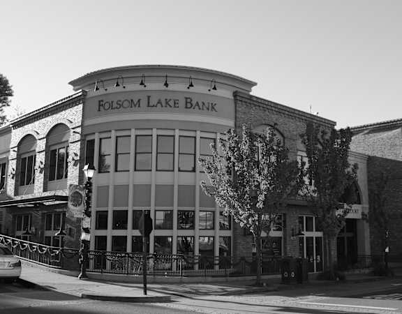 A black and white image of a building with the name Folsom Lake Bank on it.