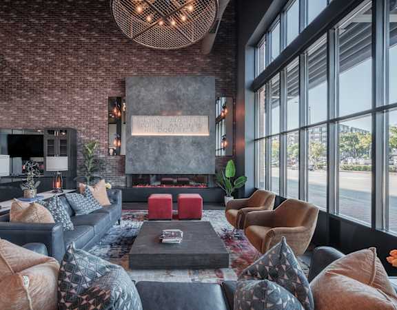 a living room with couches and chairs and a fireplace