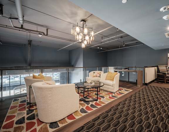a living room with couches and chairs and a table