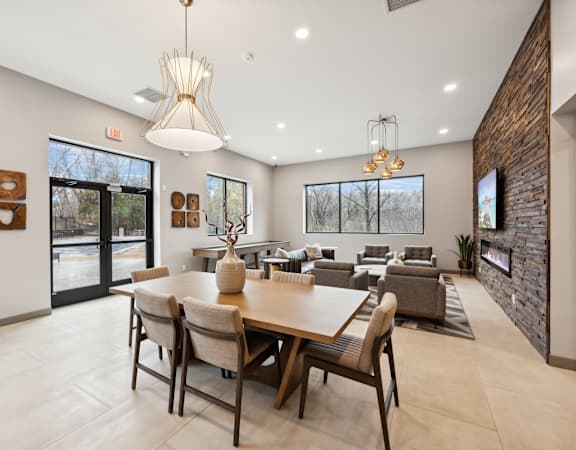 a dining room with a large table and chairs and a living room with couches