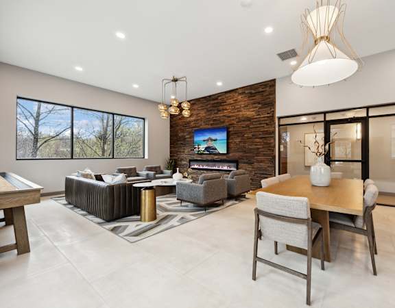 the living room and dining room in a modern home with a tv on the wall