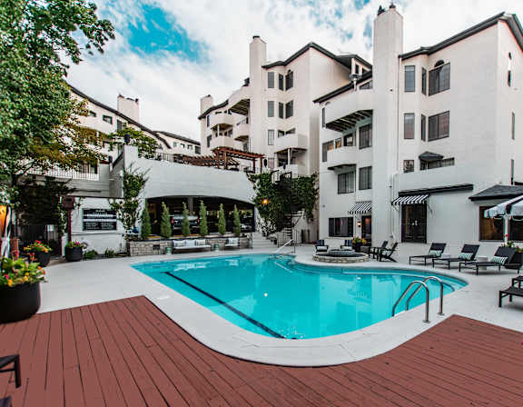 A large white building with a pool in front.