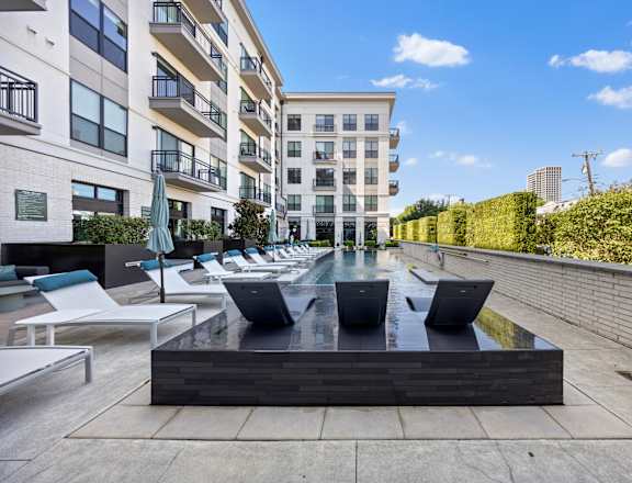 A modern outdoor seating area with a water feature in the center.