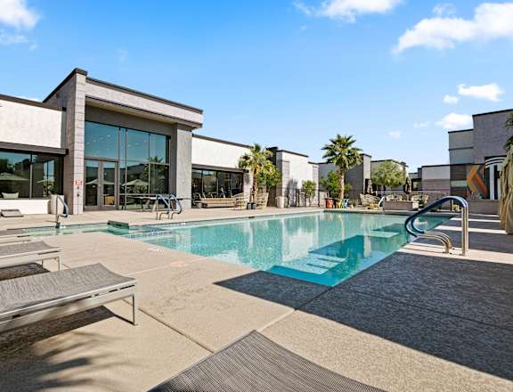 A swimming pool in front of a modern building.