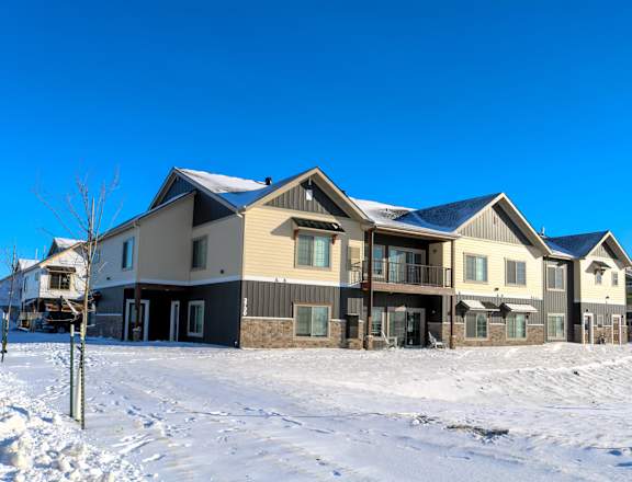 A row of houses with snow on the ground.