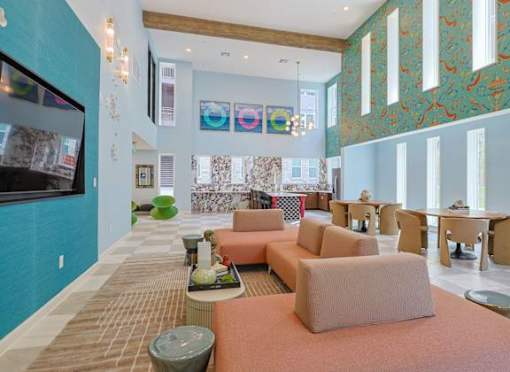 A living room with a television on the wall and a couch.