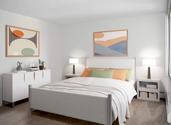 A bedroom with a bed, nightstands, and two framed artworks on the wall.
