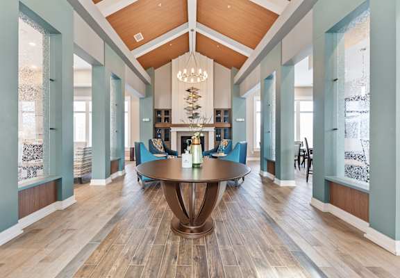 A large wooden table is in the middle of a room with blue walls.