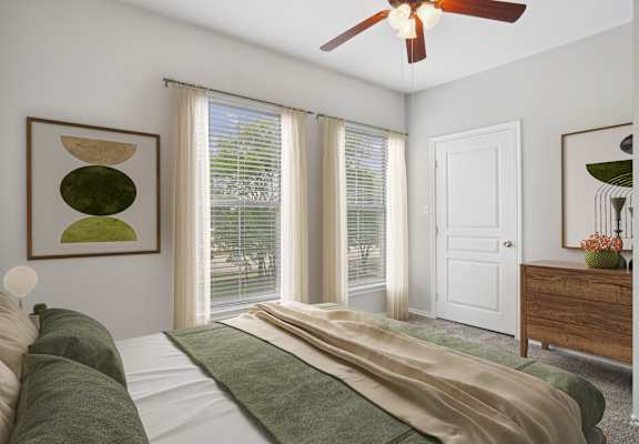 a bedroom with a bed and a ceiling fan