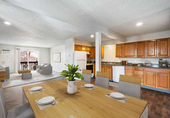 a living room and dining room with a table and chairs