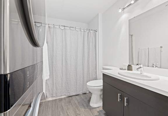 a bathroom with a shower and a sink and a toilet