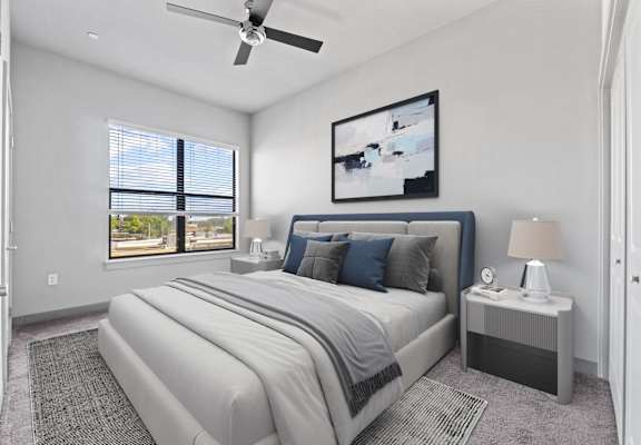 a white bedroom with a white bed and a ceiling fan