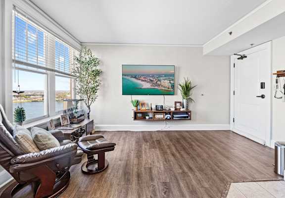 a living room with a couch and a chair and a large window