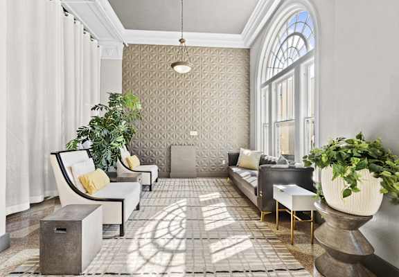 a living room filled with furniture and a large window
