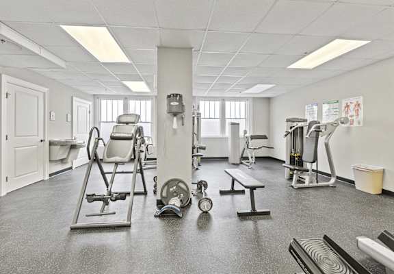 a gym with various machines and weights in it