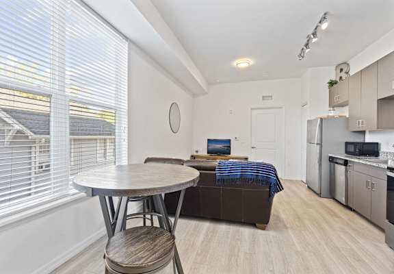 a kitchen and living room with a couch and a table