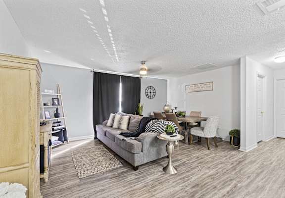 a living room and dining room with a couch and a table