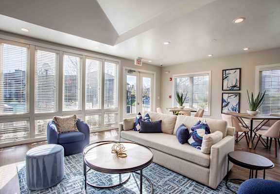A living room with a couch, chairs, and a coffee table.