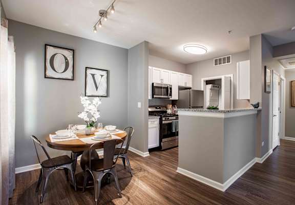 A kitchen with a dining table set for four.
