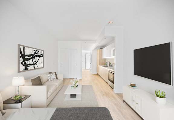 A modern living room with a white couch, a coffee table, and a large painting on the wall at Aria, New York, 10038.