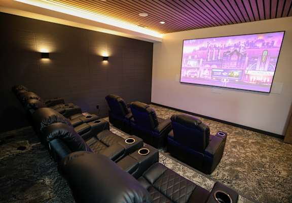 A home theater with a large screen and comfortable seating.