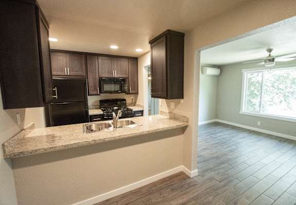 a kitchen with a large window and a counter with a sink