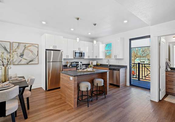 Open kitchen with stainless steel refrigerator at Current by Lotus, Ogden, UT, Utah