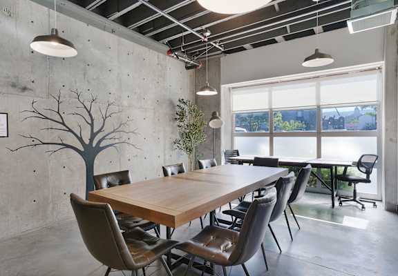 A conference room with a long table and chairs.