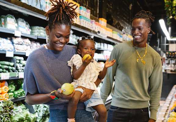 family smiling with groceries