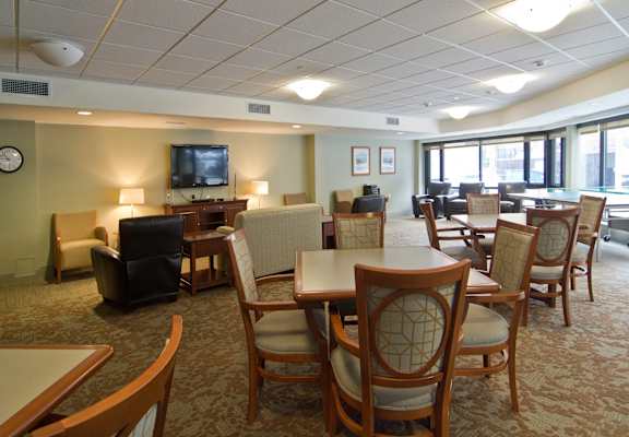 a large room with tables and chairs and a television