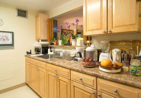 a kitchen with wooden cabinets and a granite counter top
