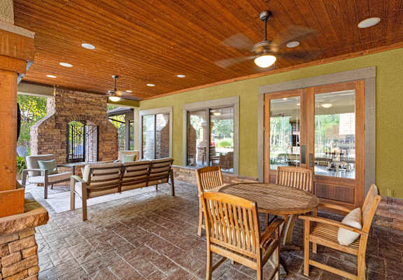 A patio with a table and chairs.