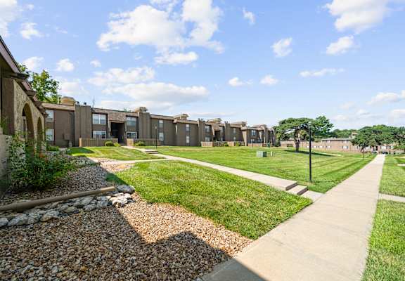 A row of houses with a gravel path in front.